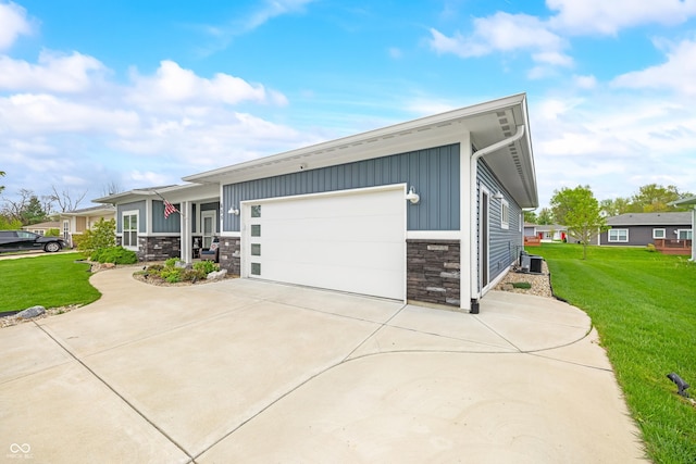655 N Sobota Way, Trafalgar, IN 46181 - view of front facade featuring stone siding, board and batten siding, a front yard, and a garage