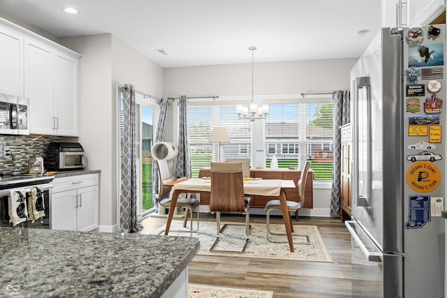 655 N Sobota Way, Trafalgar, IN 46181 - dining space featuring light wood-style floors, baseboards, recessed lighting, and a chandelier