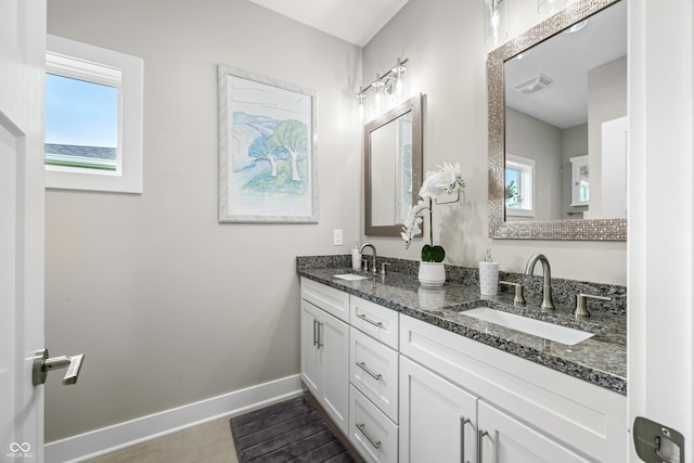 655 N Sobota Way, Trafalgar, IN 46181 - bathroom featuring baseboards, double vanity, and tile patterned floors
