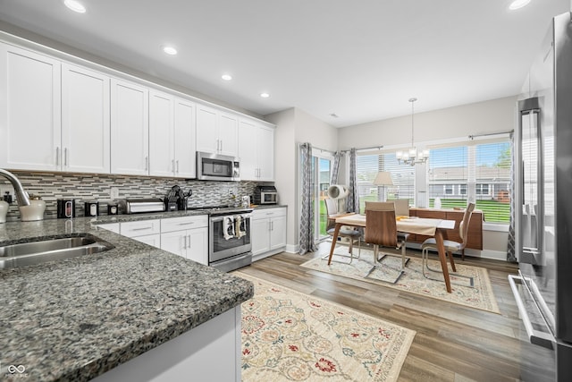 655 N Sobota Way, Trafalgar, IN 46181 - kitchen featuring stainless steel appliances, a sink, baseboards, backsplash, and recessed lighting