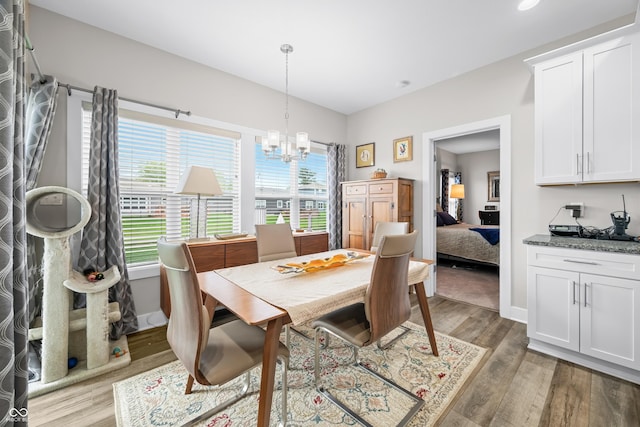 655 N Sobota Way, Trafalgar, IN 46181 - dining area with a chandelier, healthy amount of natural light, light wood-style flooring, and baseboards