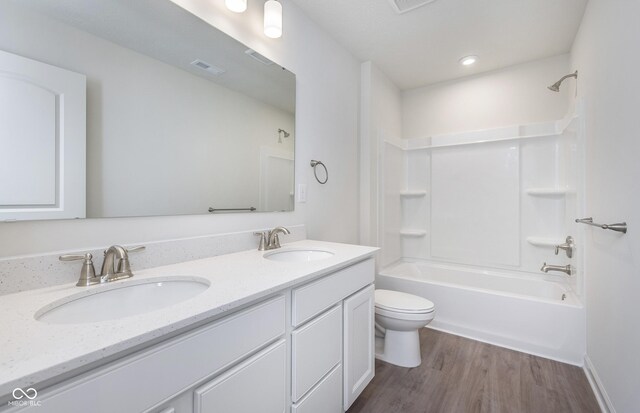 7151 Firestone Rd, Whitestown, IN 46052 - full bathroom featuring double vanity, wood finished floors, toilet, and bathtub / shower combination