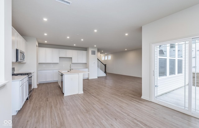 7151 Firestone Rd, Whitestown, IN 46052 - kitchen with stainless steel appliances, plenty of natural light, a sink, light wood finished floors, and recessed lighting