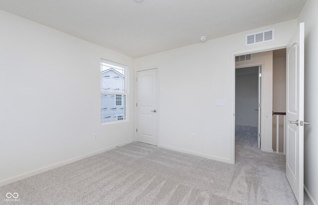 7151 Firestone Rd, Whitestown, IN 46052 - empty room featuring light carpet, baseboards, and a smoke detector