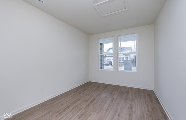 7151 Firestone Rd, Whitestown, IN 46052 - empty room featuring attic access and light wood-style flooring