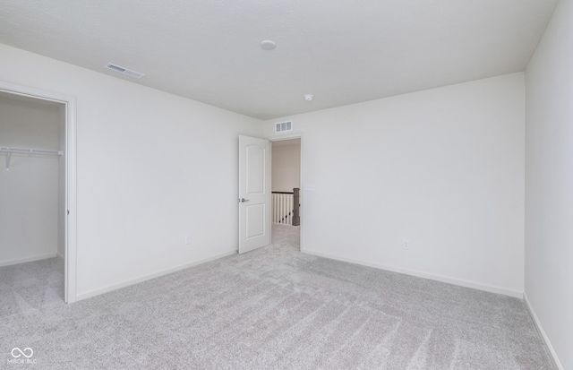 7151 Firestone Rd, Whitestown, IN 46052 - unfurnished bedroom featuring carpet floors, a walk in closet, and baseboards