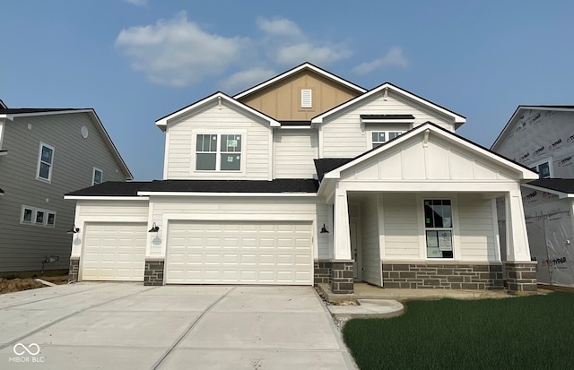 7151 Firestone Rd, Whitestown, IN 46052 - view of front of property with board and batten siding, stone siding, driveway, and covered porch
