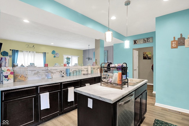 10902 Jimmy Lake Dr, Indianapolis, IN 46239 - kitchen featuring light wood finished floors, decorative backsplash, dark cabinets, pendant lighting, and recessed lighting