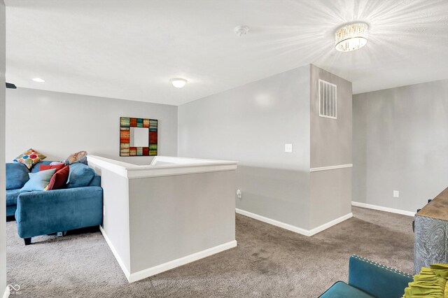 10902 Jimmy Lake Dr, Indianapolis, IN 46239 - carpeted living area with baseboards and a chandelier