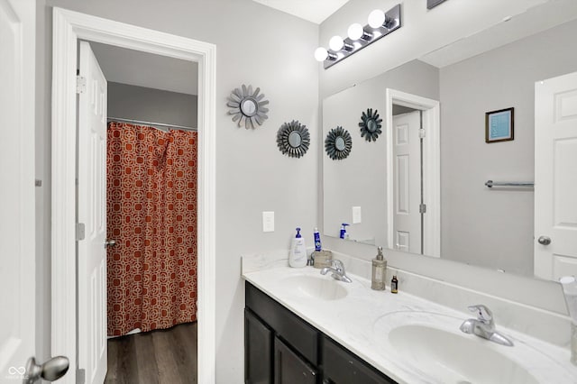 10902 Jimmy Lake Dr, Indianapolis, IN 46239 - full bathroom with double vanity and wood finished floors