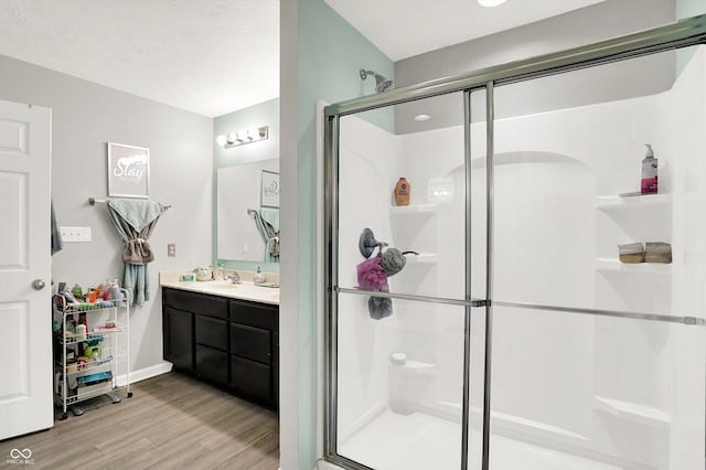 10902 Jimmy Lake Dr, Indianapolis, IN 46239 - bathroom with wood finished floors, a shower stall, and vanity