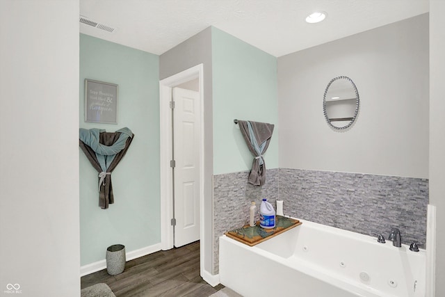 10902 Jimmy Lake Dr, Indianapolis, IN 46239 - bathroom with wood finished floors and a tub with jets