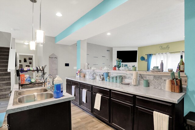 10902 Jimmy Lake Dr, Indianapolis, IN 46239 - kitchen with light wood finished floors, light countertops, pendant lighting, dark cabinetry, and recessed lighting