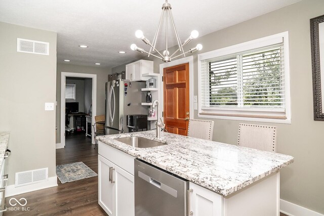 6180 Winnpeny Ln, Indianapolis, IN 46220 - kitchen with stainless steel appliances, baseboards, a sink, white cabinets, and dark wood-type flooring
