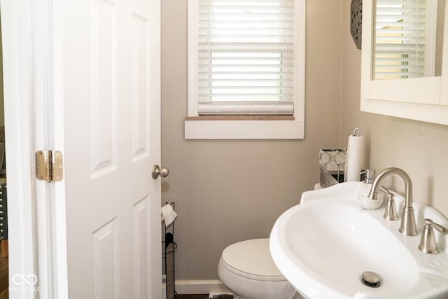 6180 Winnpeny Ln, Indianapolis, IN 46220 - half bathroom featuring a sink and toilet