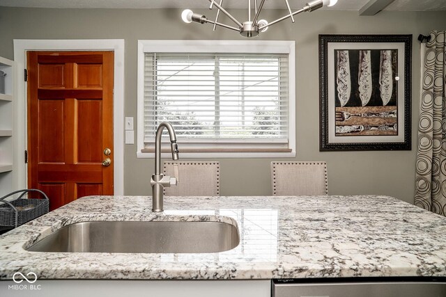 6180 Winnpeny Ln, Indianapolis, IN 46220 - kitchen featuring a sink, light stone counters, and a chandelier
