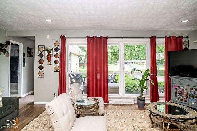 6180 Winnpeny Ln, Indianapolis, IN 46220 - living room featuring plenty of natural light, wood finished floors, baseboards, and recessed lighting