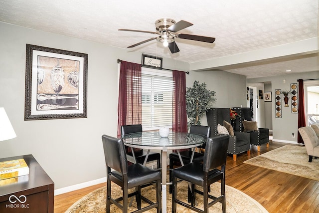 6180 Winnpeny Ln, Indianapolis, IN 46220 - dining space with light wood-style floors, a textured ceiling, ceiling fan, and baseboards
