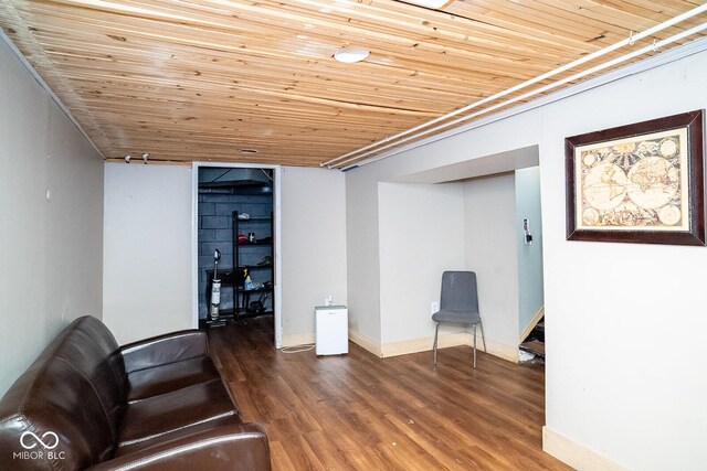 6180 Winnpeny Ln, Indianapolis, IN 46220 - unfurnished living room featuring wooden ceiling, wood finished floors, and baseboards
