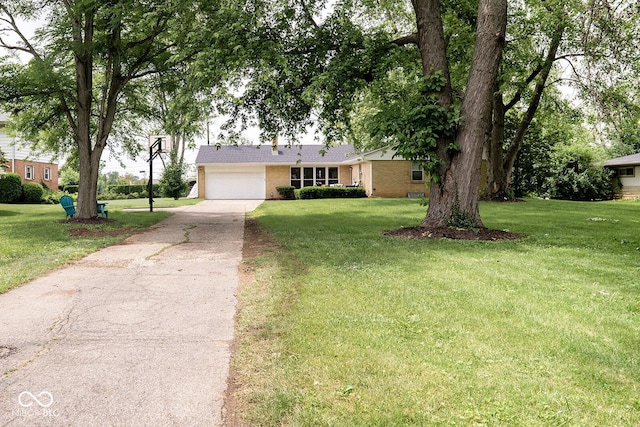 6180 Winnpeny Ln, Indianapolis, IN 46220 - view of front of house with concrete driveway, brick siding, an attached garage, and a front lawn