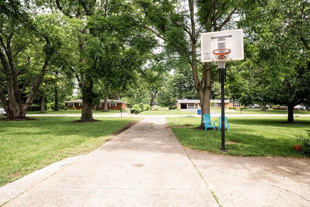 6180 Winnpeny Ln, Indianapolis, IN 46220 - surrounding community with driveway, a yard, and view of wooded area
