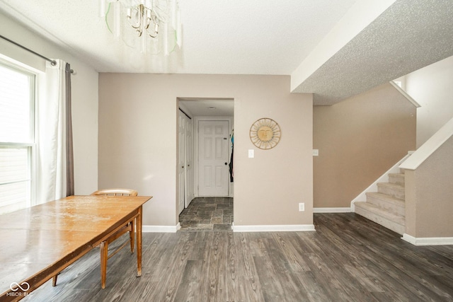 1139 Maple Stream Dr, Indianapolis, IN 46217 - dining space featuring baseboards, wood finished floors, stairs, a chandelier, and a textured ceiling