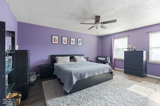 6608 Sonesta Dr, Indianapolis, IN 46217 - bedroom with wood finished floors, a textured ceiling, and ceiling fan