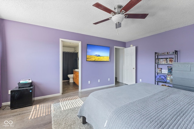 6608 Sonesta Dr, Indianapolis, IN 46217 - bedroom with wood finished floors, a textured ceiling, connected bathroom, and ceiling fan
