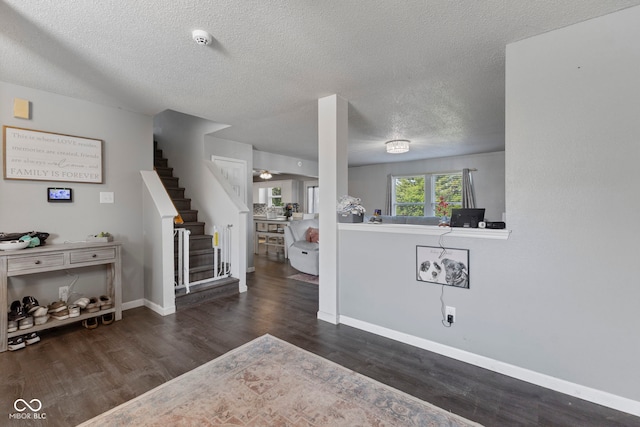6608 Sonesta Dr, Indianapolis, IN 46217 - living area featuring wood finished floors, stairway, and a textured ceiling
