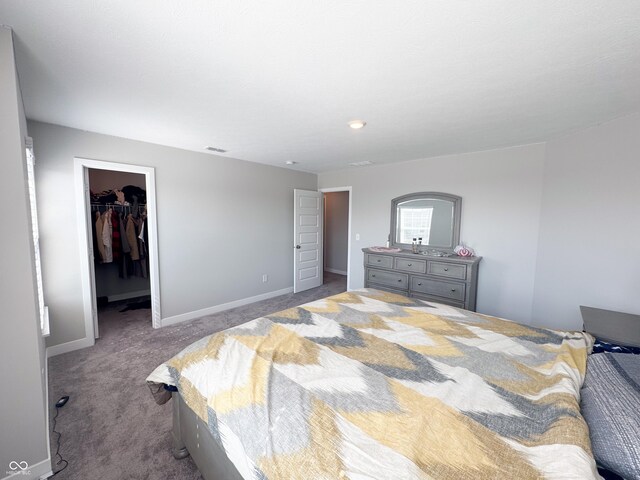 2358 S Stonehill Way, New Palestine, IN 46163 - carpeted bedroom featuring baseboards and a walk in closet