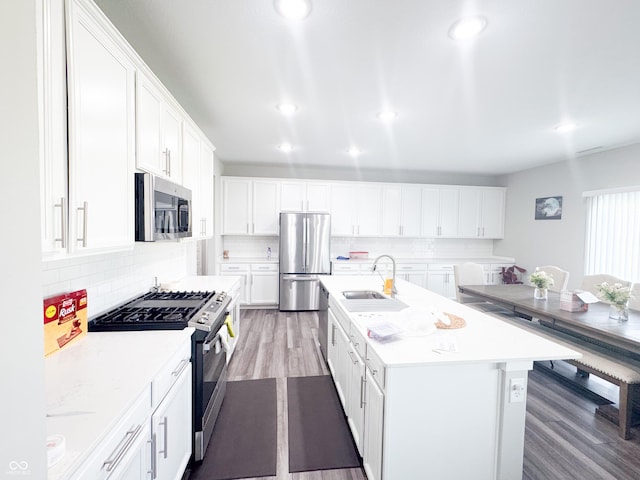 2358 S Stonehill Way, New Palestine, IN 46163 - kitchen featuring appliances with stainless steel finishes, light wood-style floors, tasteful backsplash, light countertops, and white cabinets