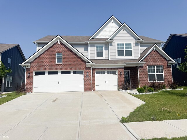 2358 S Stonehill Way, New Palestine, IN 46163 - craftsman-style house featuring driveway, a front lawn, brick siding, and an attached garage