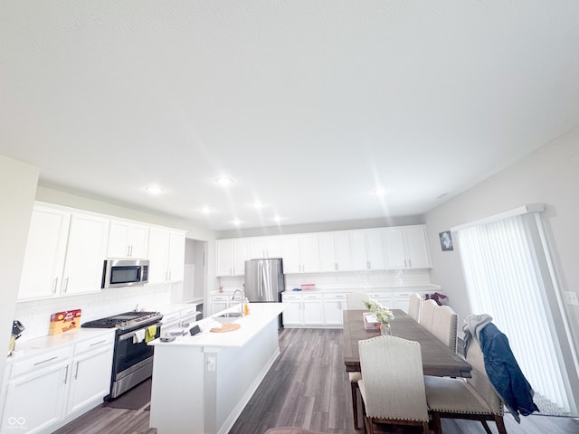 2358 S Stonehill Way, New Palestine, IN 46163 - kitchen featuring stainless steel appliances, backsplash, a center island with sink, white cabinetry, and recessed lighting