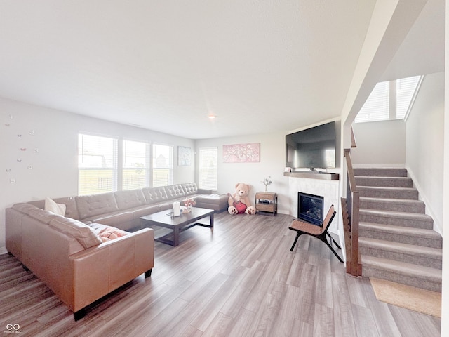 2358 S Stonehill Way, New Palestine, IN 46163 - living area featuring a tiled fireplace, light wood finished floors, and stairway