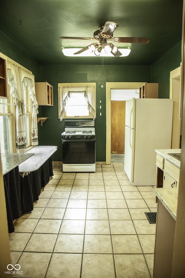 1115 N Kealing Ave, Indianapolis, IN 46201 - kitchen featuring white appliances, light tile patterned floors, ceiling fan, and light countertops