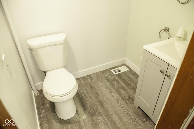 1115 N Kealing Ave, Indianapolis, IN 46201 - bathroom with toilet, vanity, wood finished floors, and baseboards