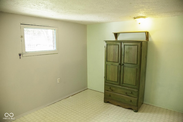 1115 N Kealing Ave, Indianapolis, IN 46201 - unfurnished bedroom with a textured ceiling, light flooring, and baseboards