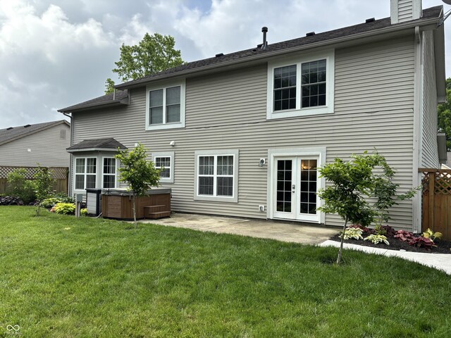 8926 Durban Ct, Indianapolis, IN 46234 - rear view of property with a hot tub, a patio area, french doors, and a chimney