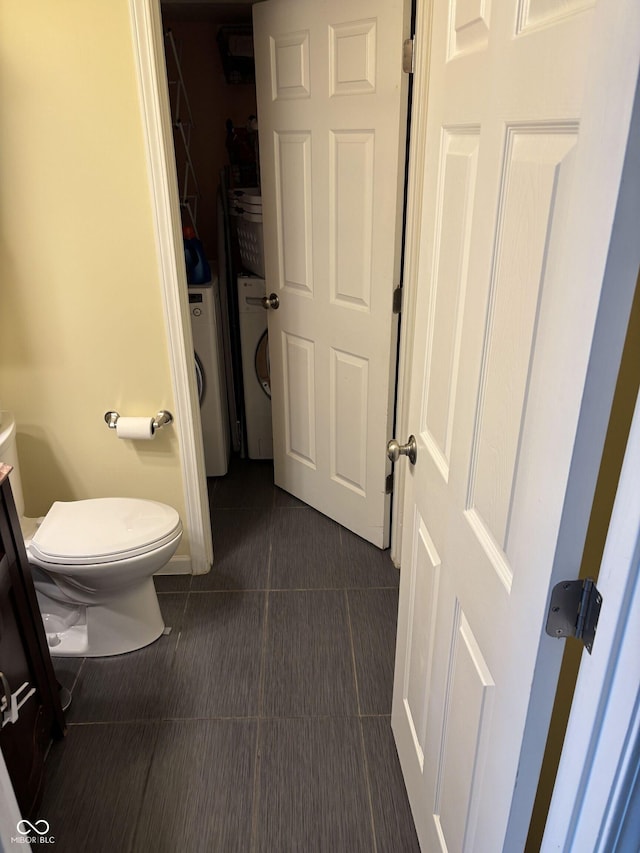 8926 Durban Ct, Indianapolis, IN 46234 - bathroom featuring washer / clothes dryer, toilet, and tile patterned flooring