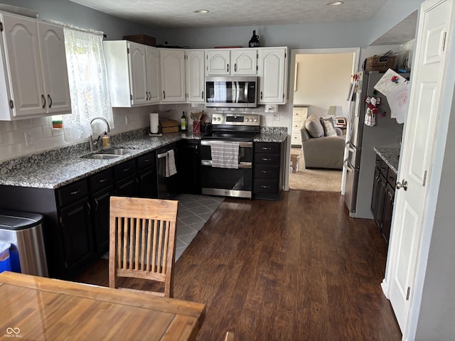 8926 Durban Ct, Indianapolis, IN 46234 - kitchen with stainless steel appliances, a sink, white cabinetry, and decorative backsplash