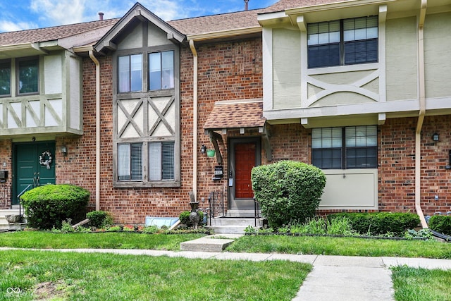 8121 Bromley Pl, Indianapolis, IN 46219 - multi unit property featuring brick siding and a front lawn