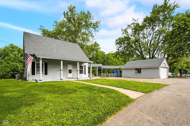 379 N Marion St, Morgantown, IN 46160 - view of front of home featuring a front yard, covered porch, an outbuilding, and roof with shingles