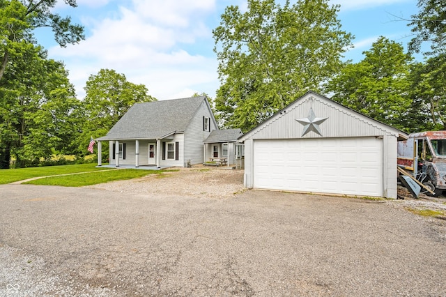 379 N Marion St, Morgantown, IN 46160 - view of front of property featuring a shingled roof, a detached garage, and a front lawn