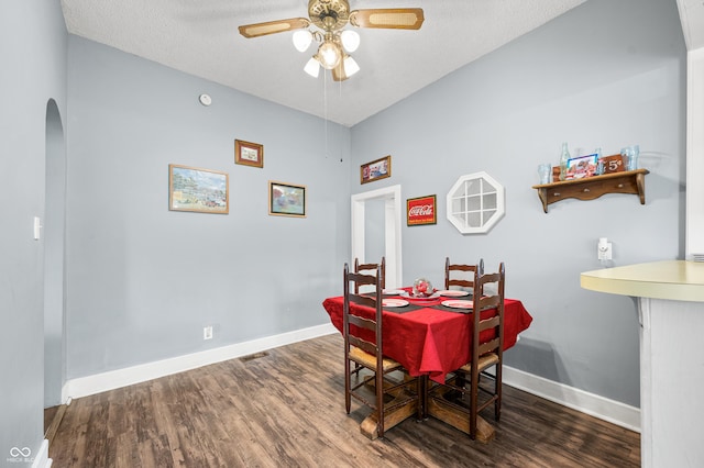 379 N Marion St, Morgantown, IN 46160 - dining room with arched walkways, a ceiling fan, wood finished floors, baseboards, and a textured ceiling