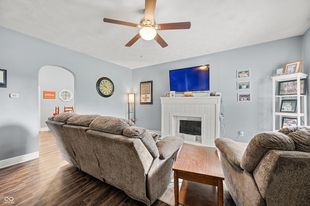 379 N Marion St, Morgantown, IN 46160 - living room with a ceiling fan, wood finished floors, arched walkways, and a fireplace
