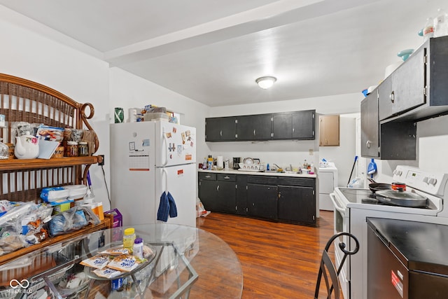 1116 N Berwick Ave, Indianapolis, IN 46222 - kitchen with white appliances, washer / dryer, dark wood-style floors, a sink, and dark cabinets