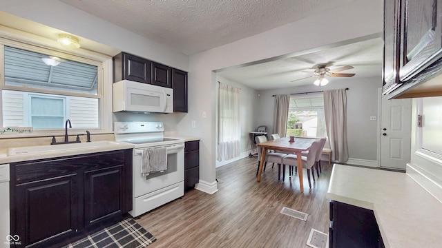 311 S 6th Ave, Beech Grove, IN 46107 - kitchen featuring white appliances, a sink, light countertops, light wood-style floors, and ceiling fan