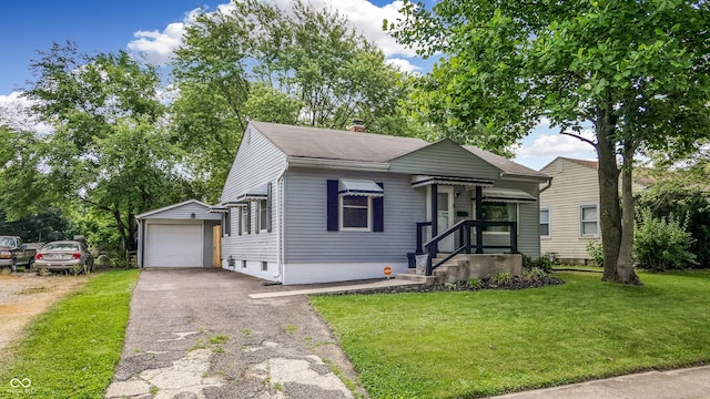 311 S 6th Ave, Beech Grove, IN 46107 - bungalow-style home featuring asphalt driveway, an outdoor structure, a garage, a front lawn, and a chimney