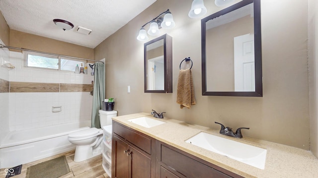 311 S 6th Ave, Beech Grove, IN 46107 - bathroom with shower / bathtub combination with curtain, toilet, double vanity, and a textured ceiling