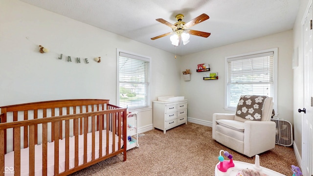 311 S 6th Ave, Beech Grove, IN 46107 - bedroom with light carpet, a crib, baseboards, and a ceiling fan